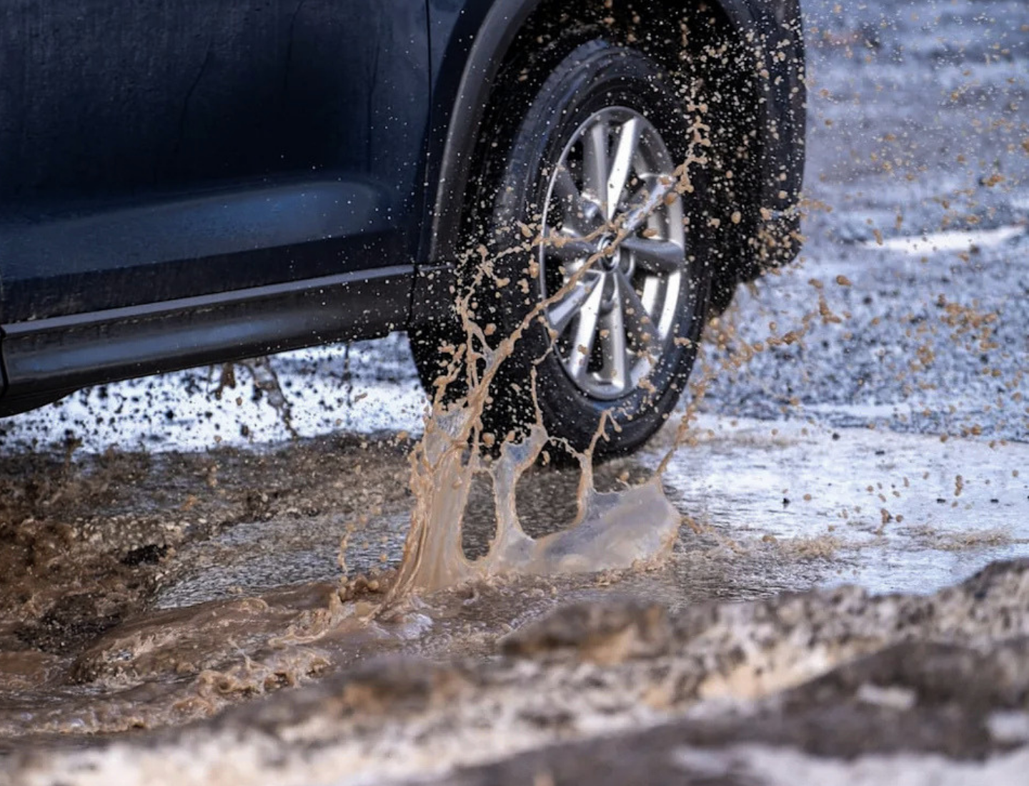 Car hitting pothole
